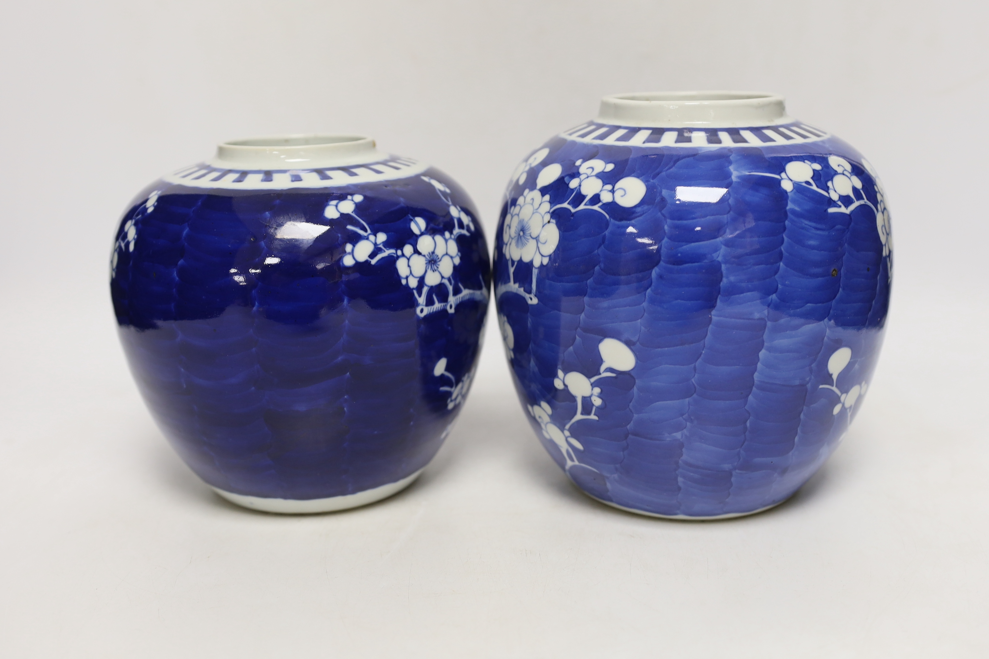 Two Chinese blue and white prunus jars, and a famille verte powder blue bowl, late 19th/early 20th century, tallest 17.5cm